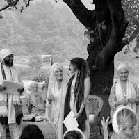 a black and white photo of a group of people at a ceremony